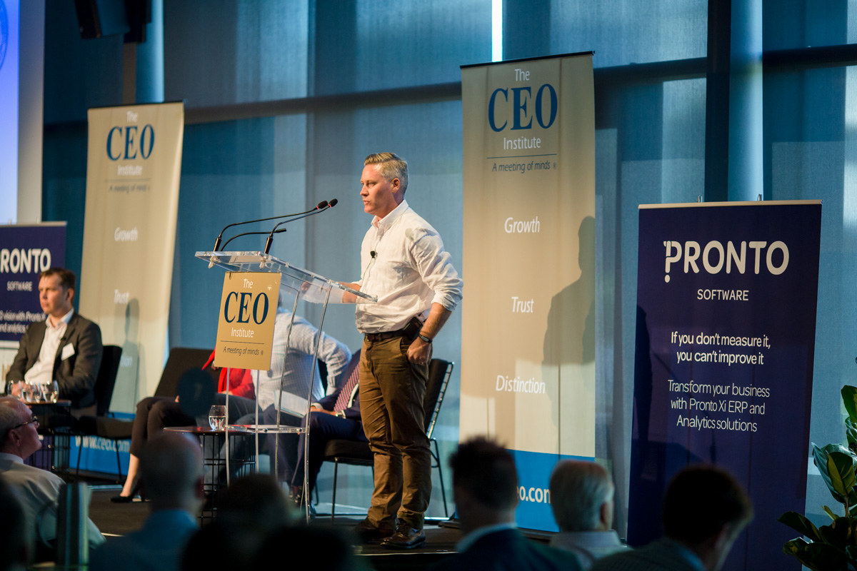 Mark Cameron on stage addressing a leadership audience at The CEO Institute