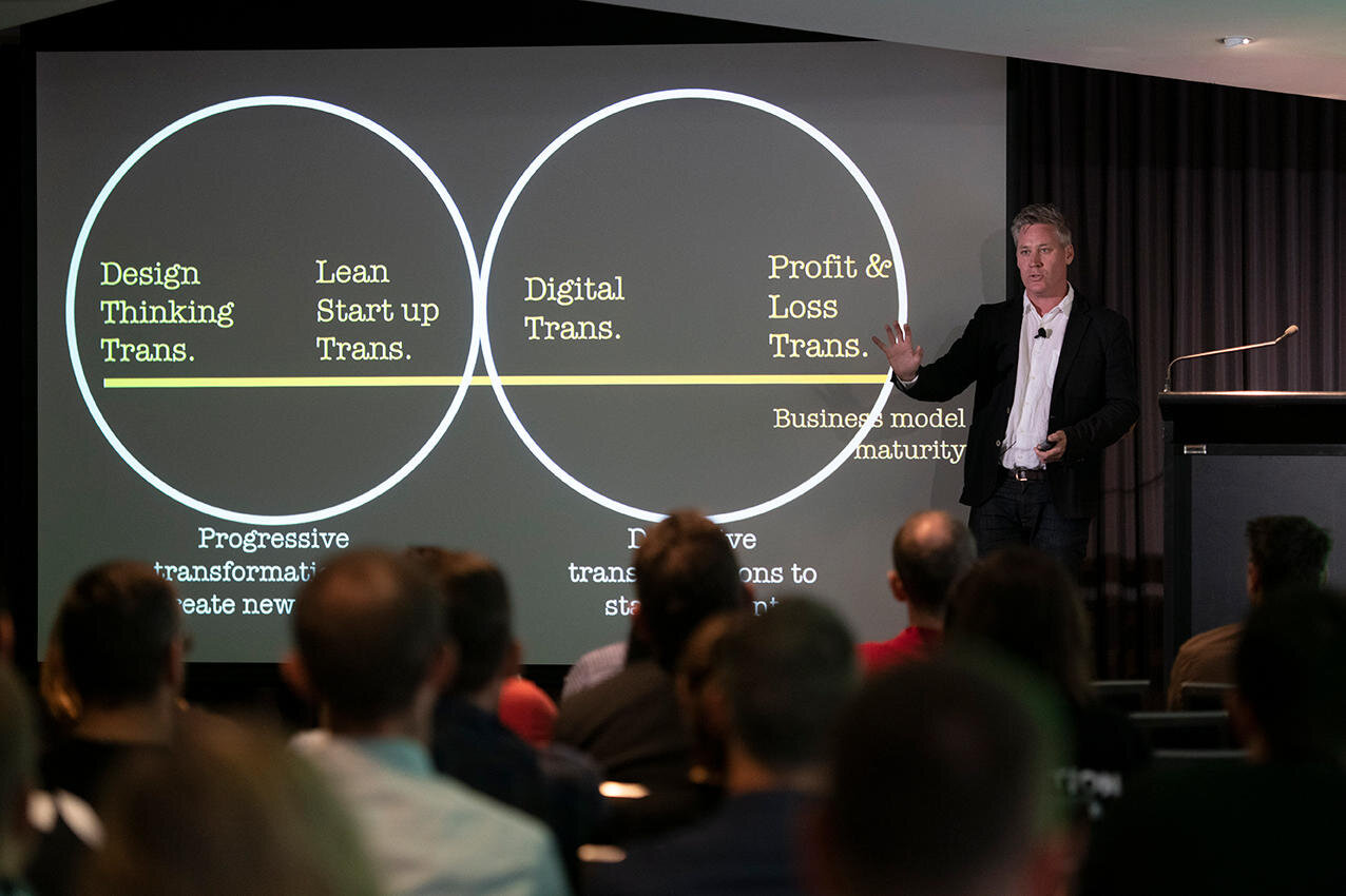 Mark Cameron explaining a business transformation model to an audience